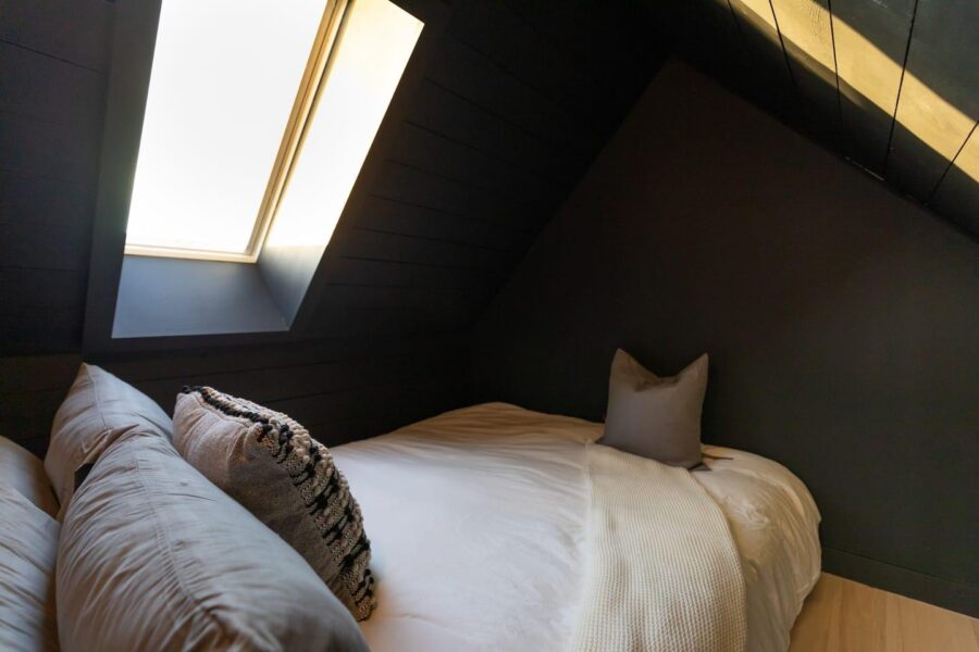 Modern Scandinavian waterfront cabin with a stargazing loft and black metal exterior in Nova Scotia.