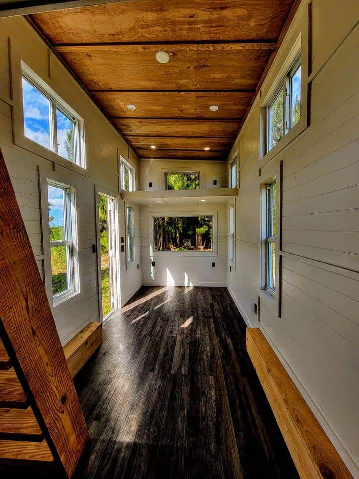 Tiny House Interior with Bright Natural Light and Wooden Ceiling.