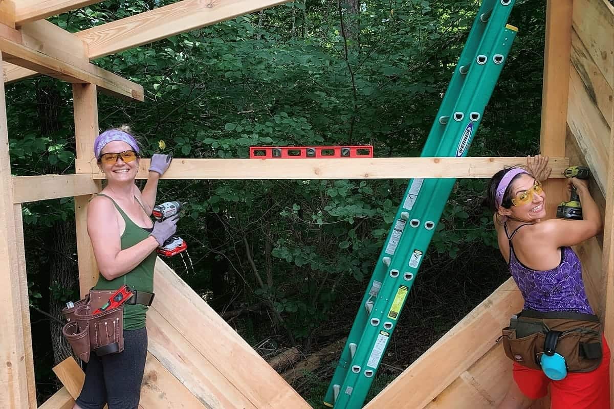 Advanced women's carpentry students raising walls on a shed build at Wild Abundance