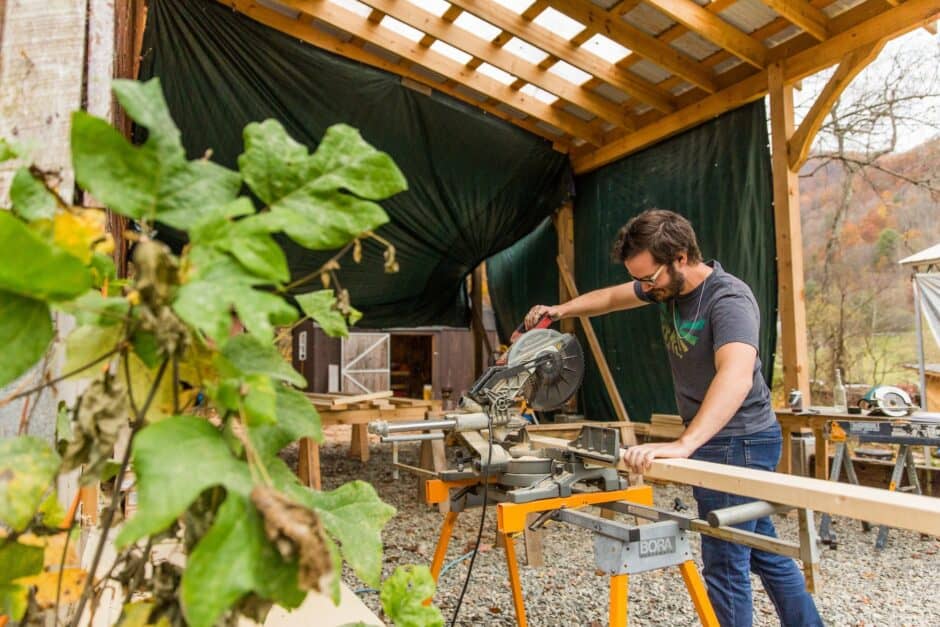 Student using a miter saw at the Wild Abundance beginner woodworking class
