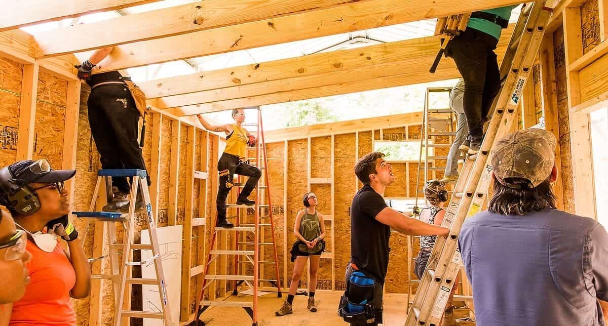 Wild Abundance students framing walls during the tiny house building workshop