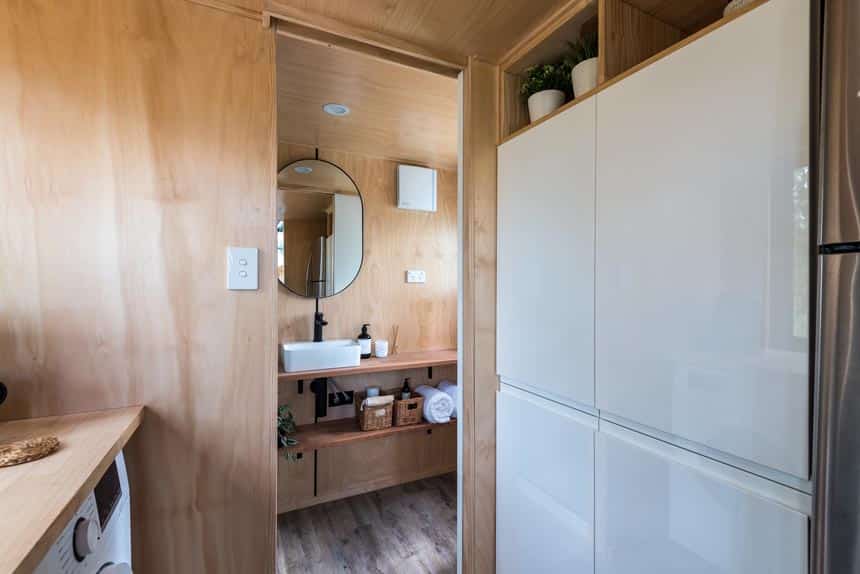 Wildscape tiny house kitchen with wood benchtop and black gooseneck mixer