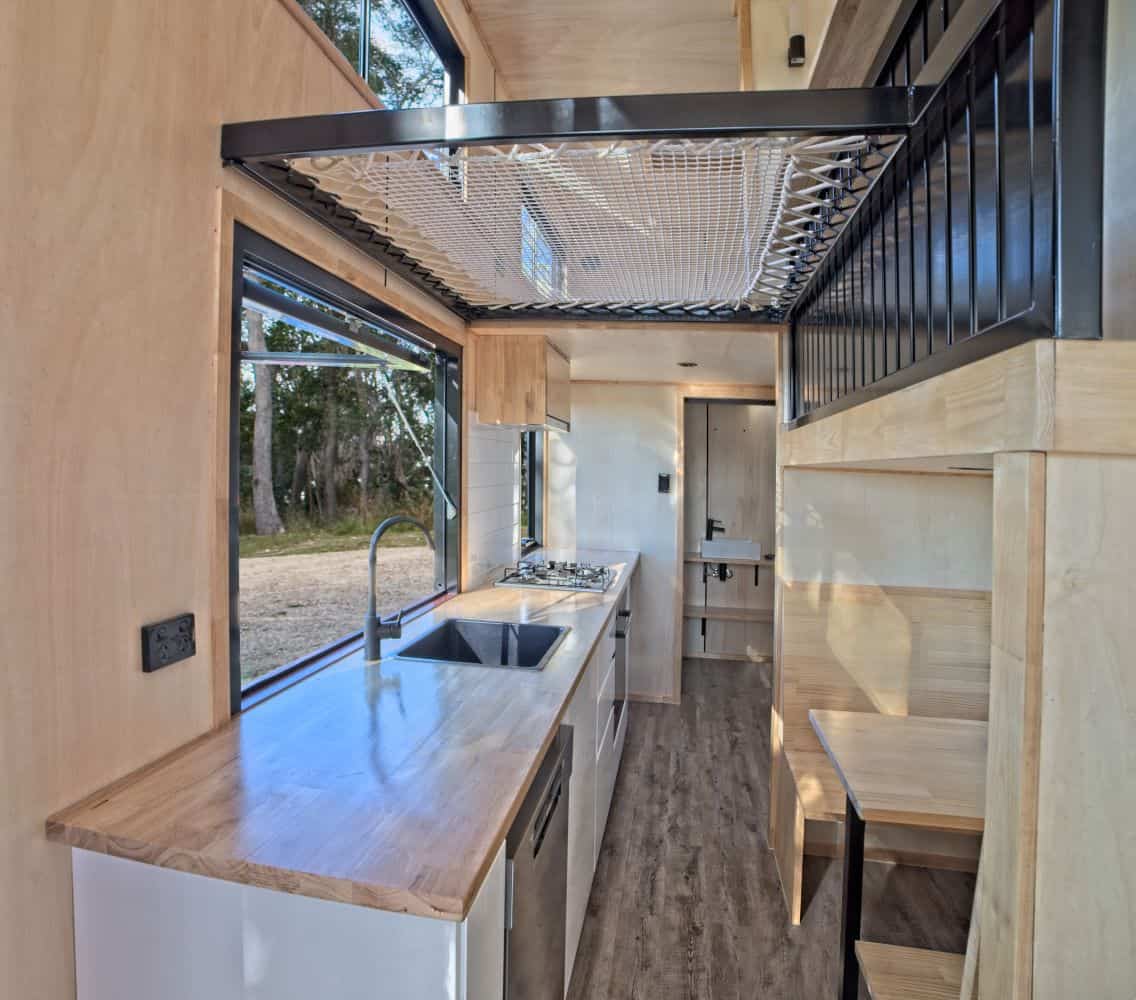 Suspended netted loft above the kitchen in the Wildscape tiny house