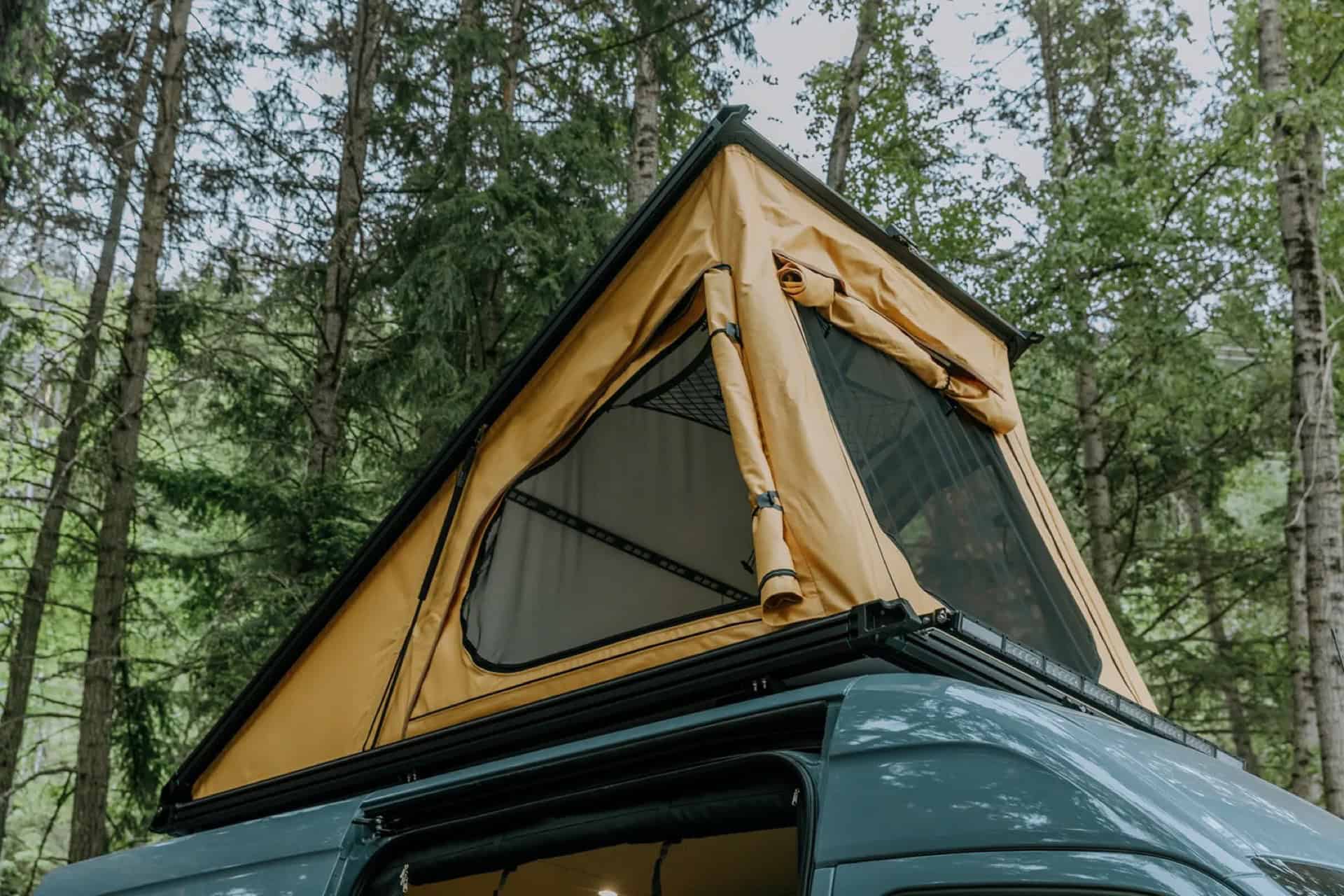 GB01 pop-top roof tent open with mesh windows, surrounded by forest