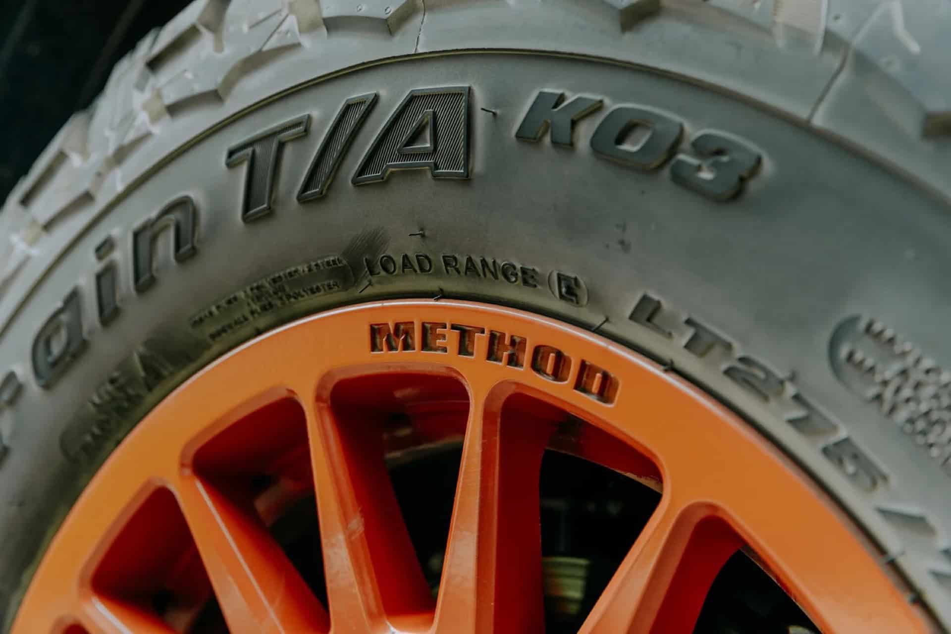 Close-up of the GB01 orange Method wheel and BFGoodrich All-Terrain T/A KO3 tire