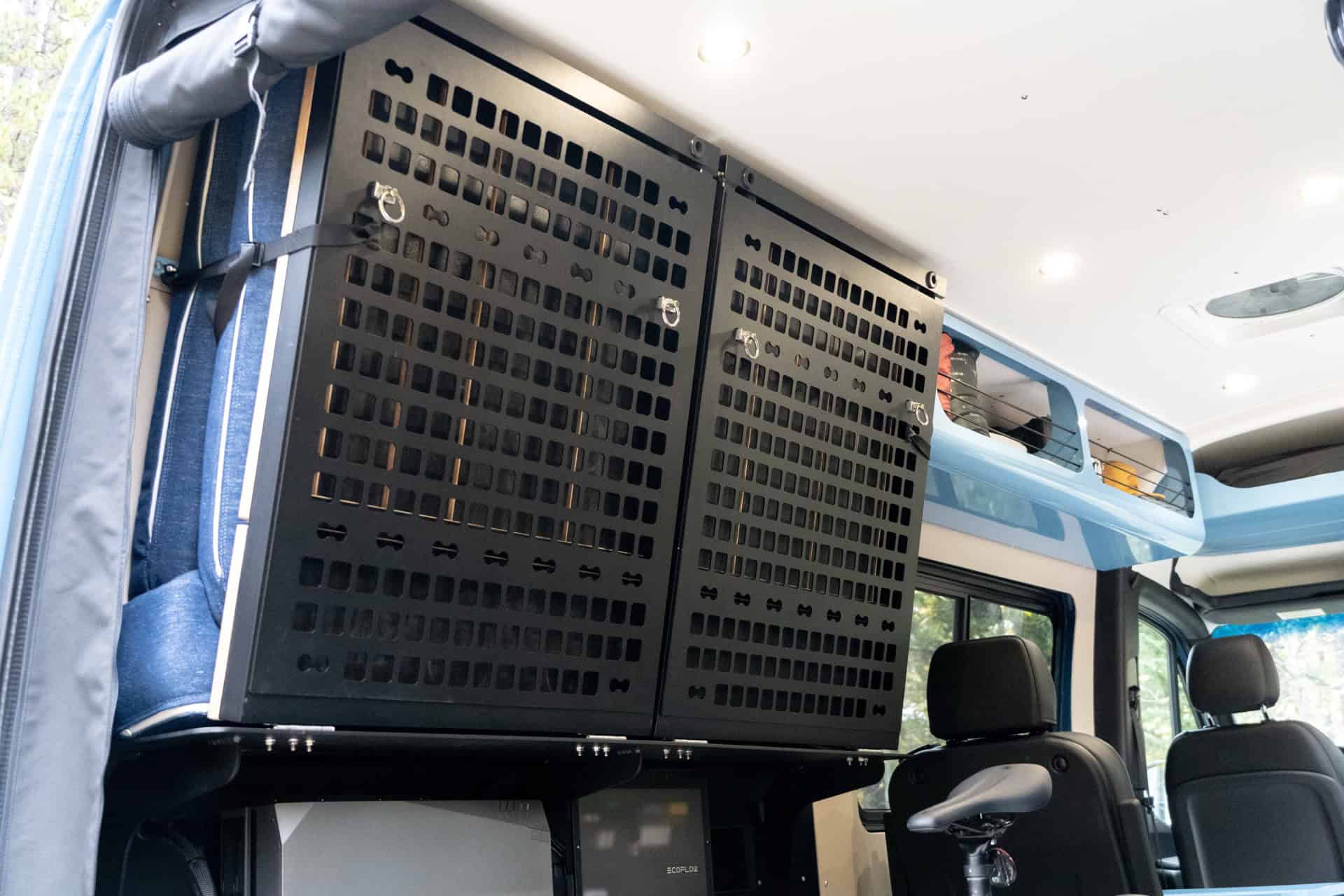 MOLLE gear panels mounted on the wall of the Peyto camper van above the bench seat