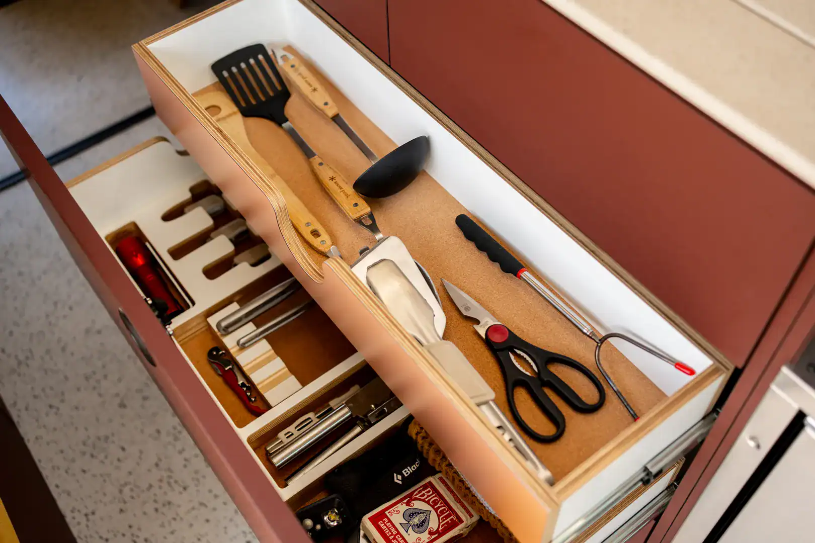 A custom-fitted utensil and tool organizer drawer in the Yama Vans Brio galley