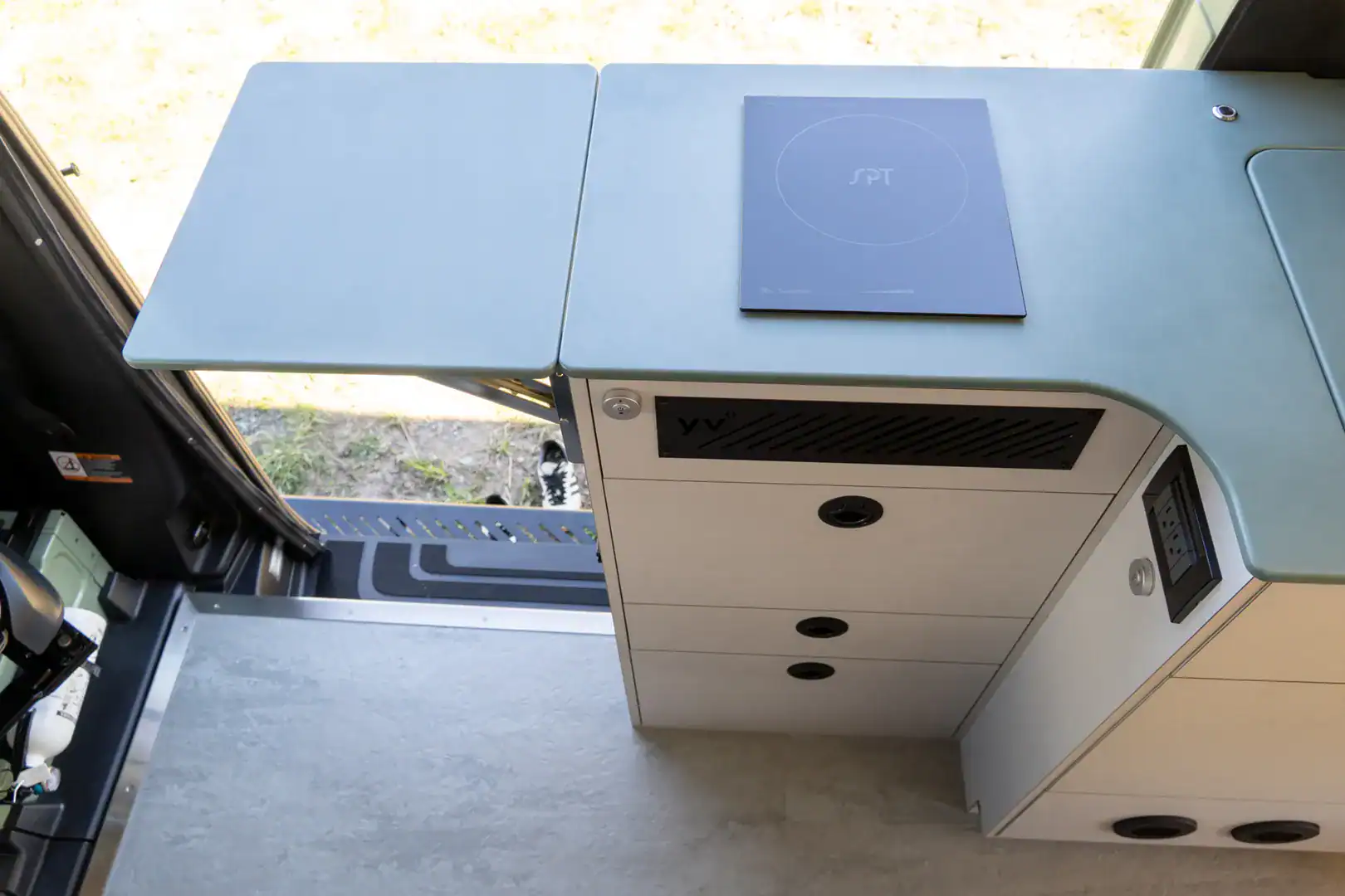 A pull-out counter extension and induction cooktop in the Yama Vans Fitz galley