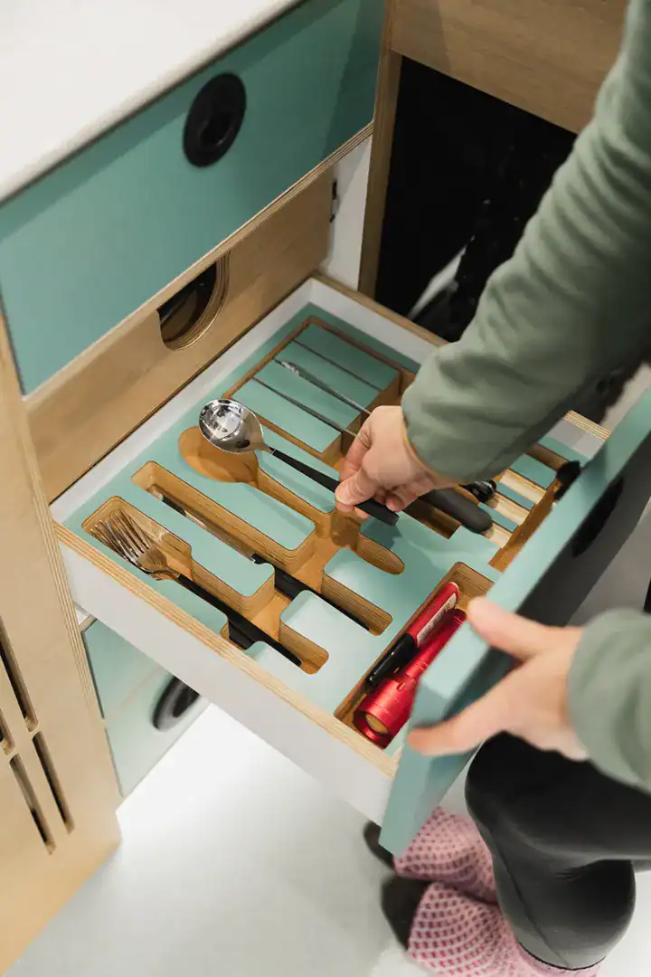 A custom-fitted utensil organizer drawer in the Yama Vans Furō galley
