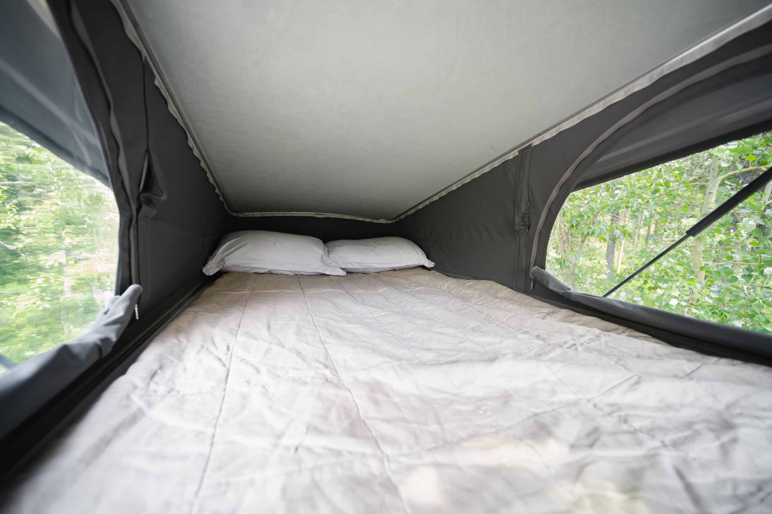 The pop-top sleeping area of the Yama Vans Gatsby with windows on both sides