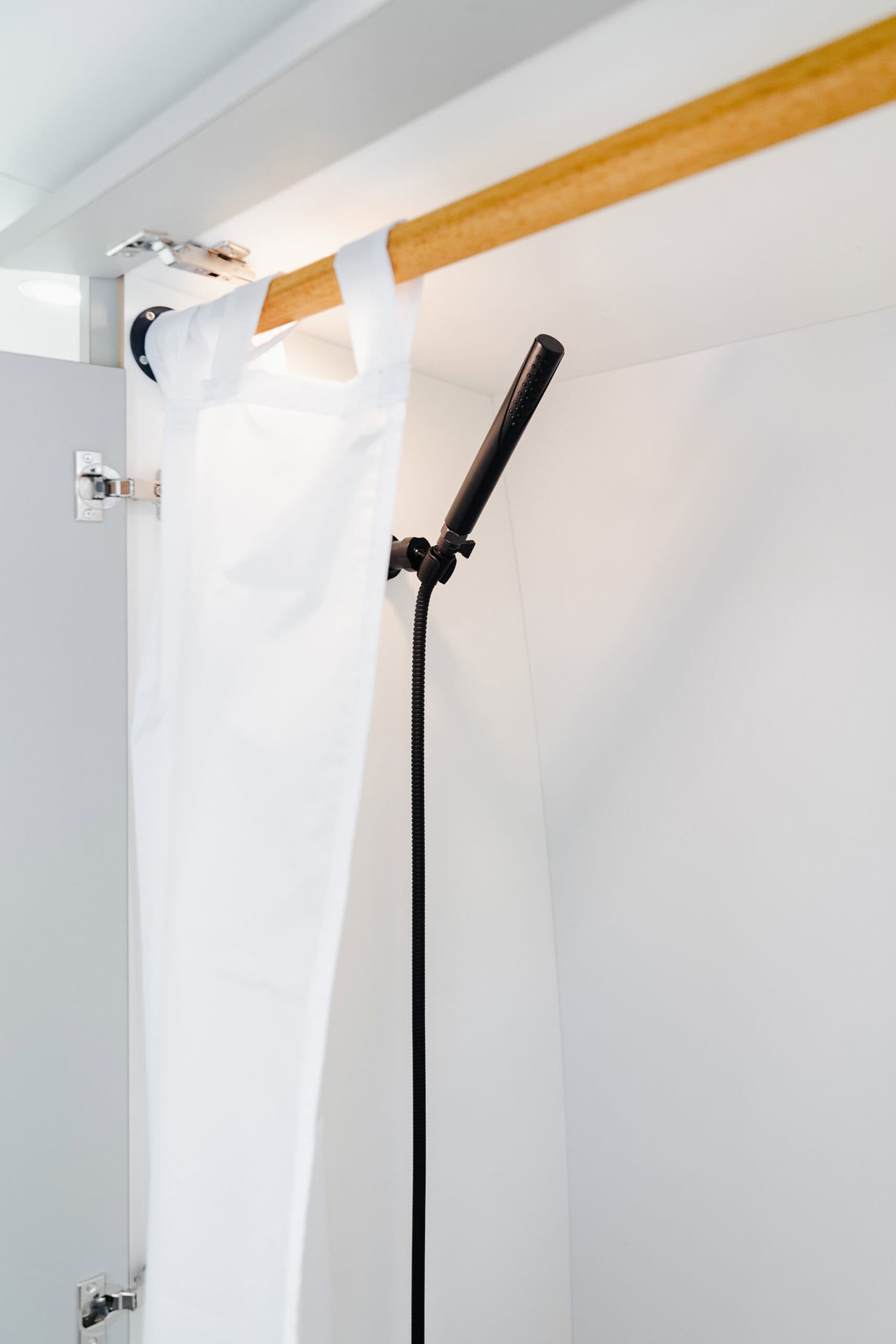 The full-height wetroom shower with a handheld sprayer inside the Yama Vans Gatsby