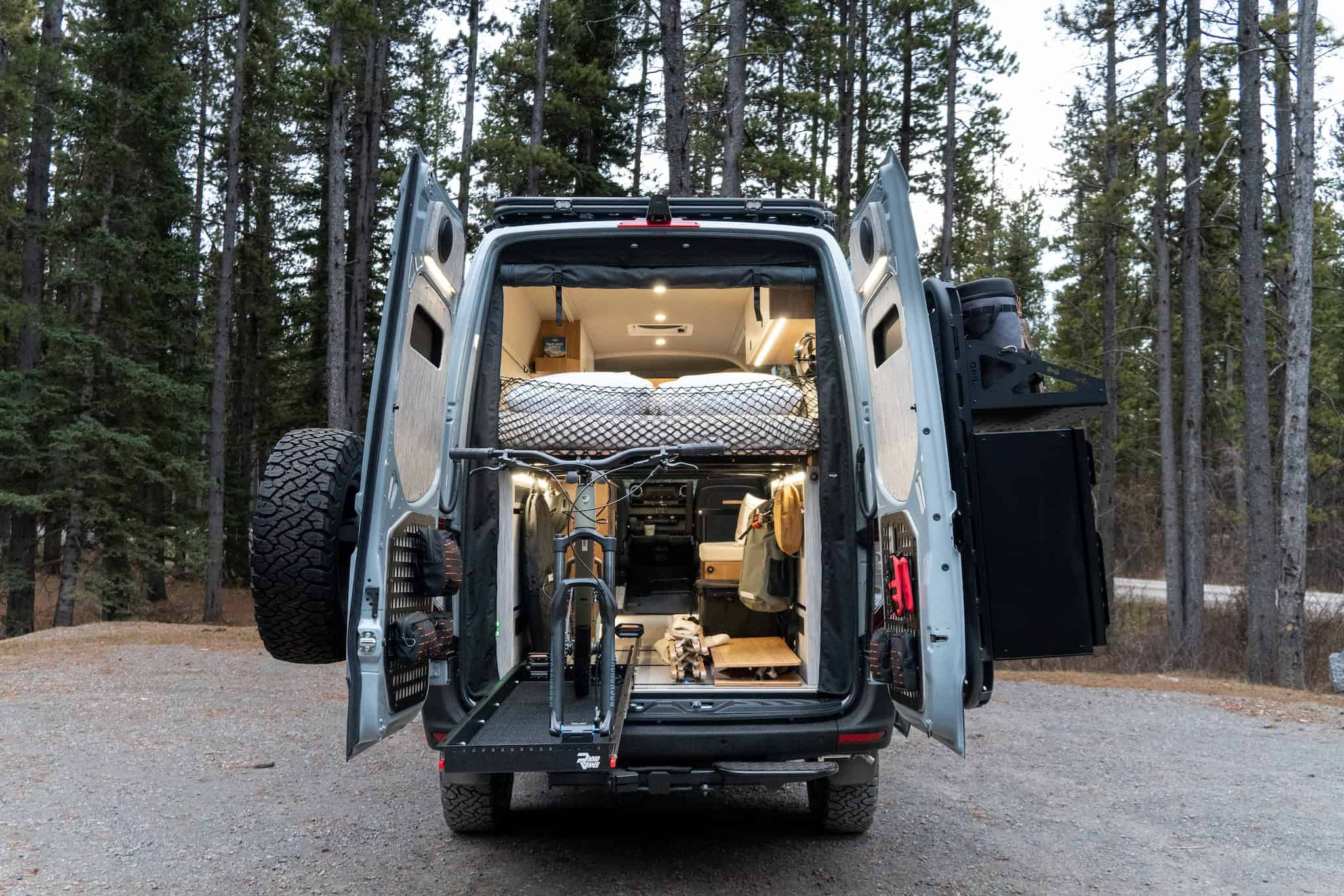The rear gear garage of the Yama Vans Trekka loaded with bikes beneath the elevated lengthwise bed