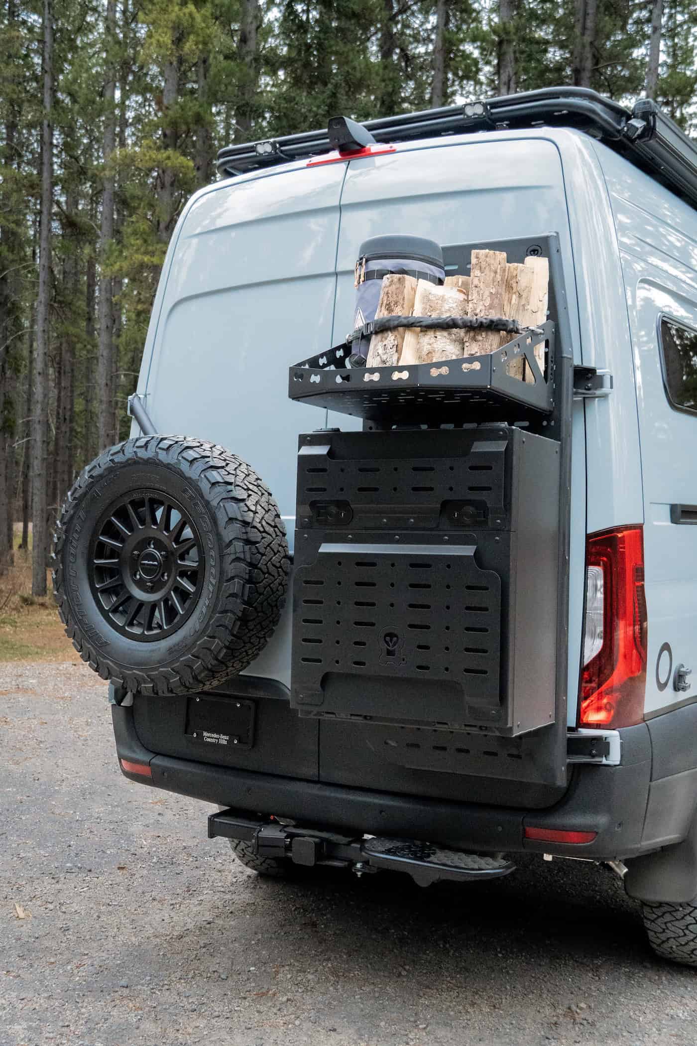 A rear swing-away cargo rack on the Yama Vans Trekka carrying firewood and a spare tire