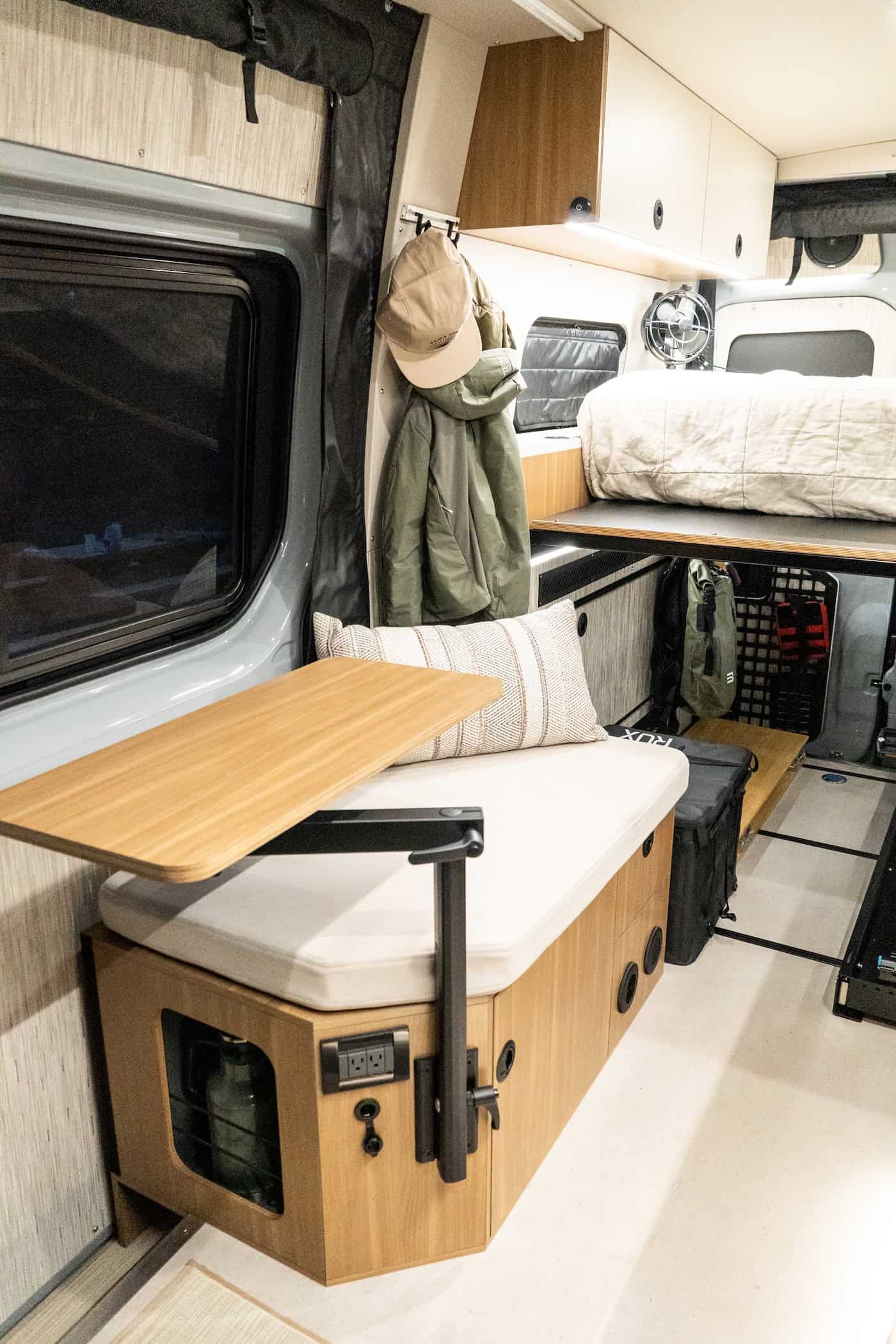 A swivel-mounted wood table set up as a work desk over the bench seat inside the Yama Vans Trekka