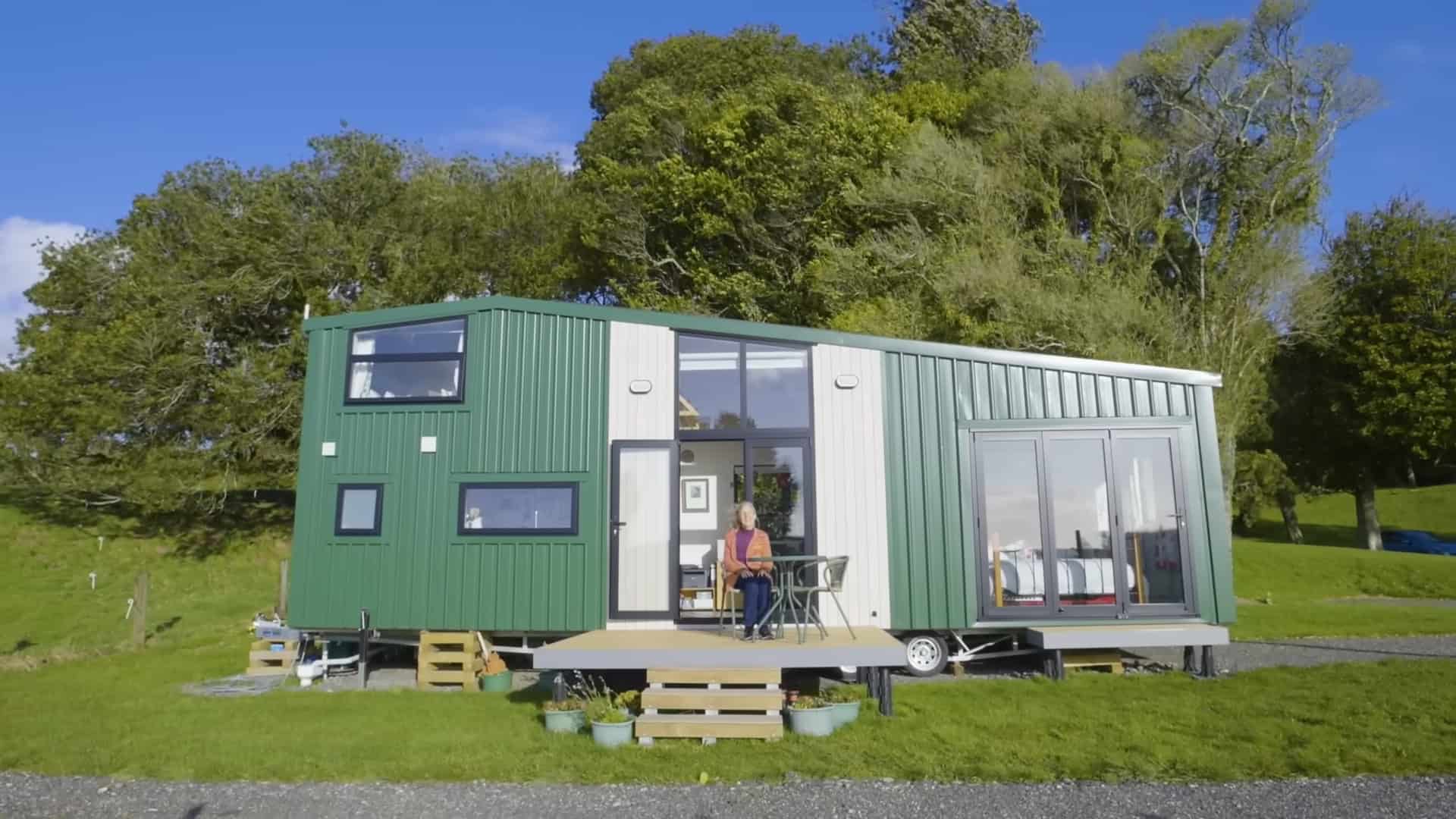 Tiny House with Green Exterior and Large Windows