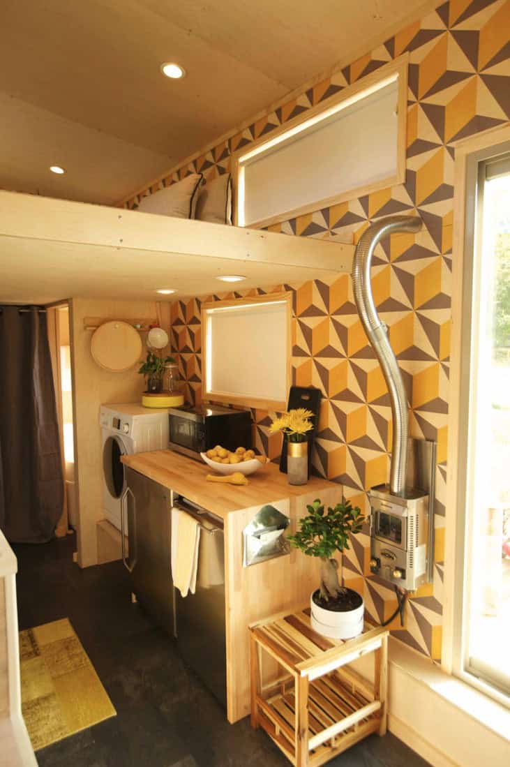 Tiny House Kitchen with modern appliances and geometric wall decor.