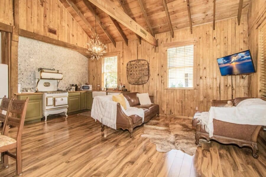 Interior of a cozy tiny farm cottage with wooden walls and rustic decor in Zephyrhills, Florida.