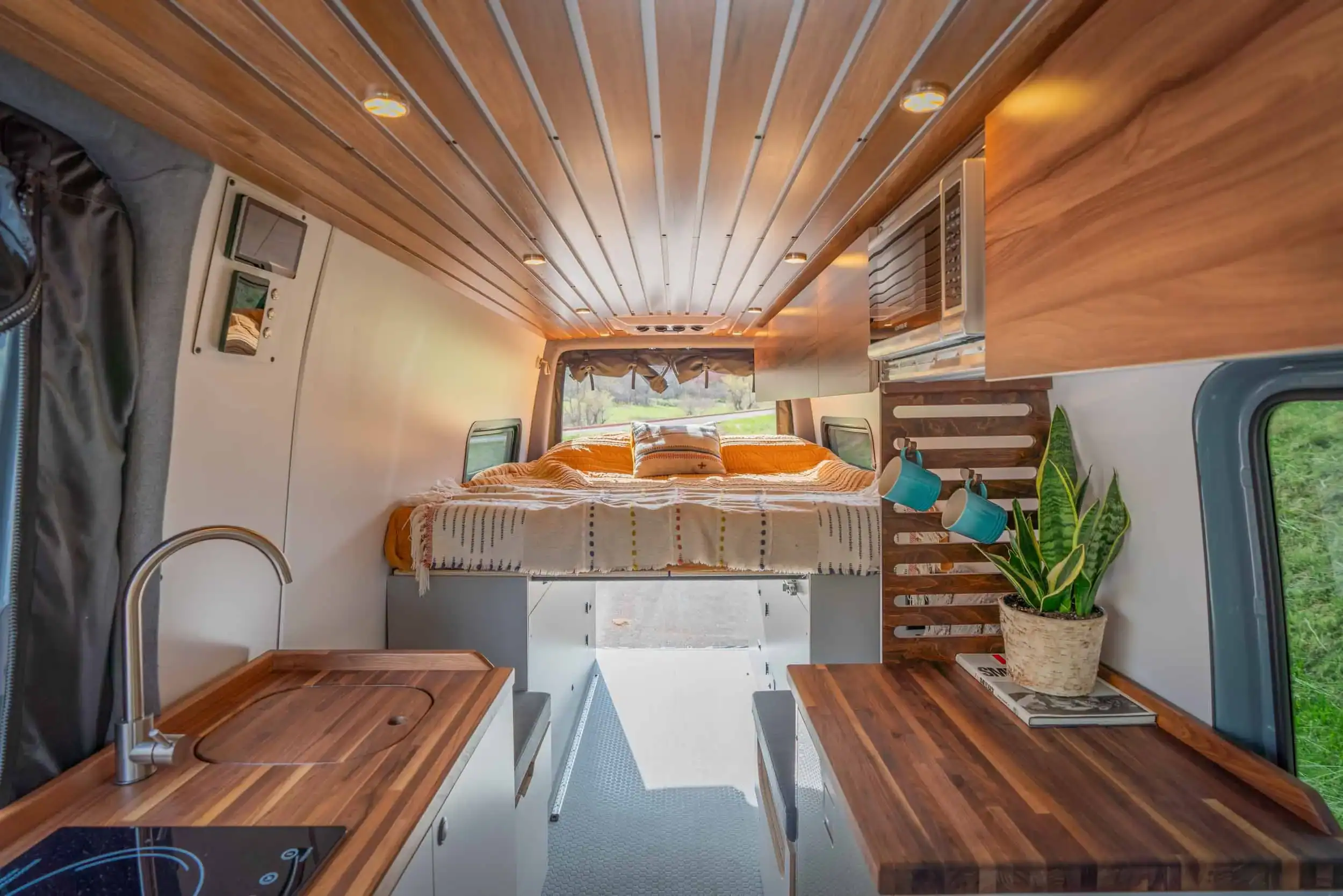Zeppelin van open-concept living area with custom cabinetry and premium wood finishes
