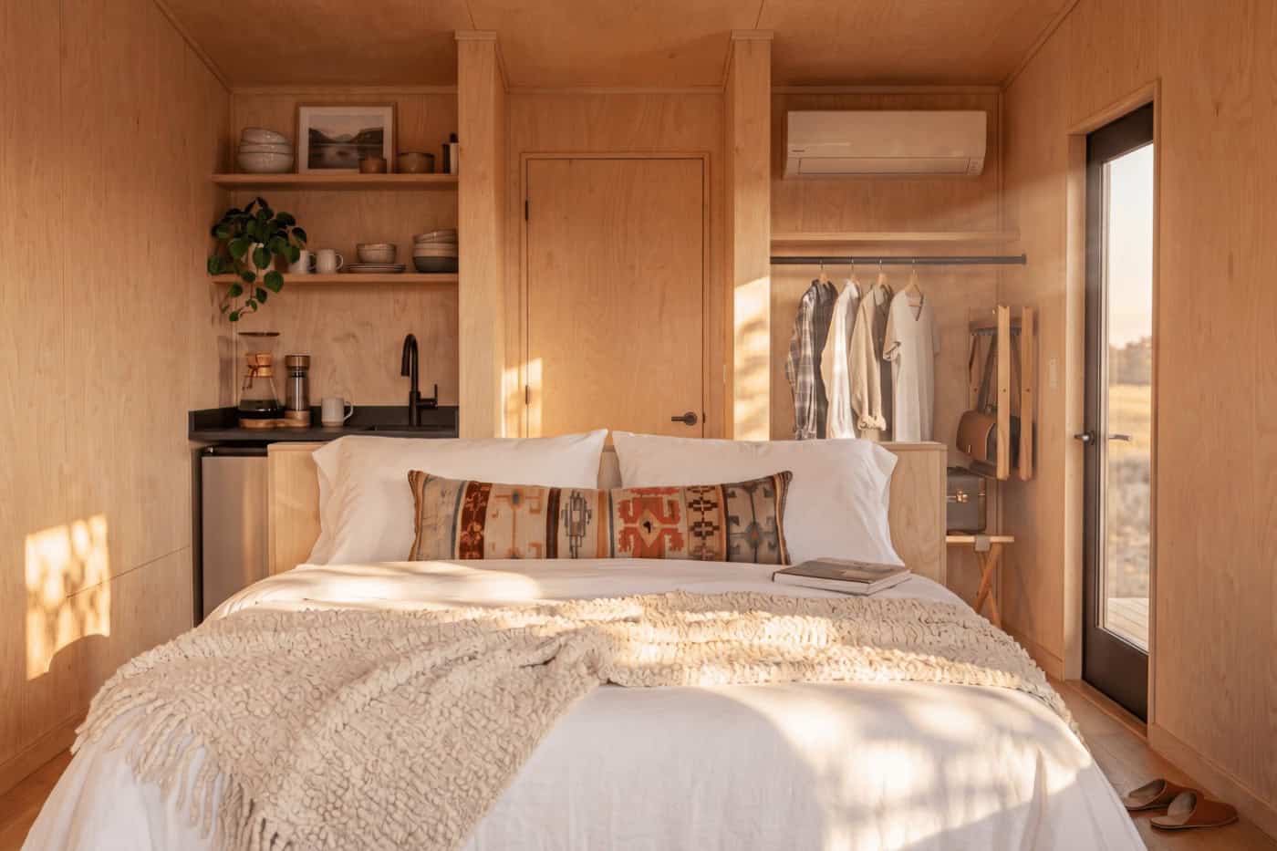 Birch plywood interior with bed and kitchenette in the Atlas park model by Zook Cabins
