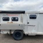 2020 AntiShanty AS-1 Plus adventure trailer in closed tow mode, side profile with kitchen box, stowed 23zero awning, and PLUS branding