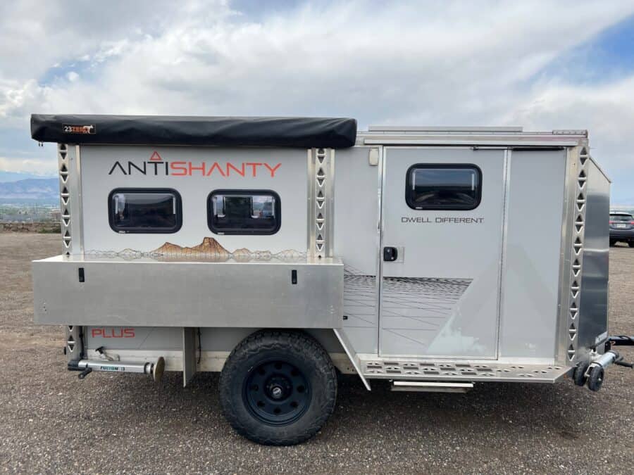 2020 AntiShanty AS-1 Plus adventure trailer in closed tow mode, side profile with kitchen box, stowed 23zero awning, and PLUS branding