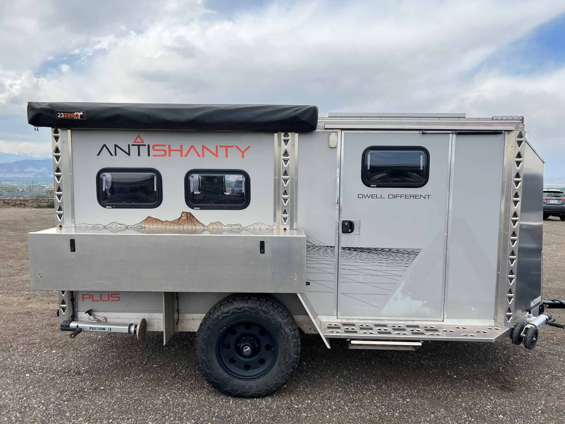 2020 AntiShanty AS-1 Plus adventure trailer in closed tow mode, side profile with kitchen box, stowed 23zero awning, and PLUS branding