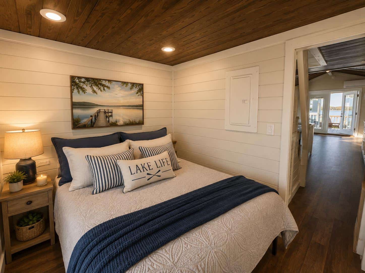 Avery 127 main-floor bedroom with white shiplap walls and wood ceiling