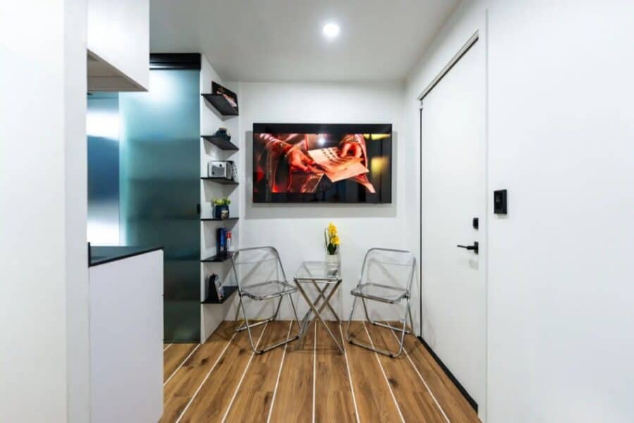 Modern tiny house interior featuring sleek furniture, a wall-mounted TV, and minimalist decor for ef.