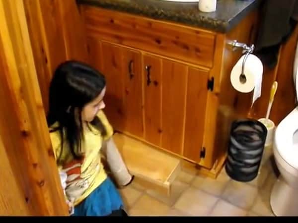 Bathroom vanity with a pull-out step for kids in the Baird family tiny cabin