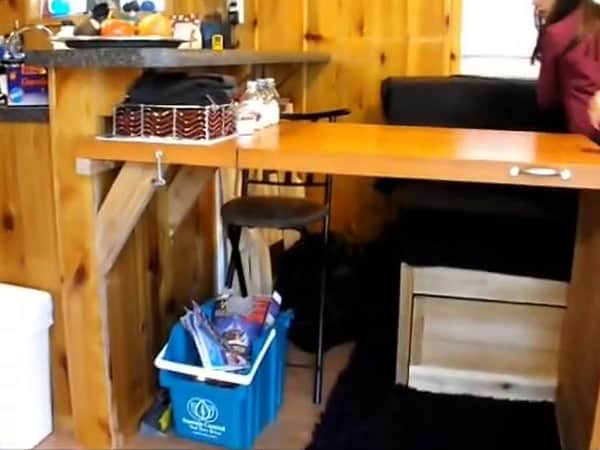 Baird family fold-out dining table extended from the kitchen counter in their tiny cabin