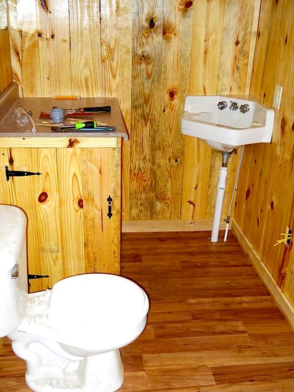 Bathroom with Toilet and Door Added for Water Heater Enclosure
