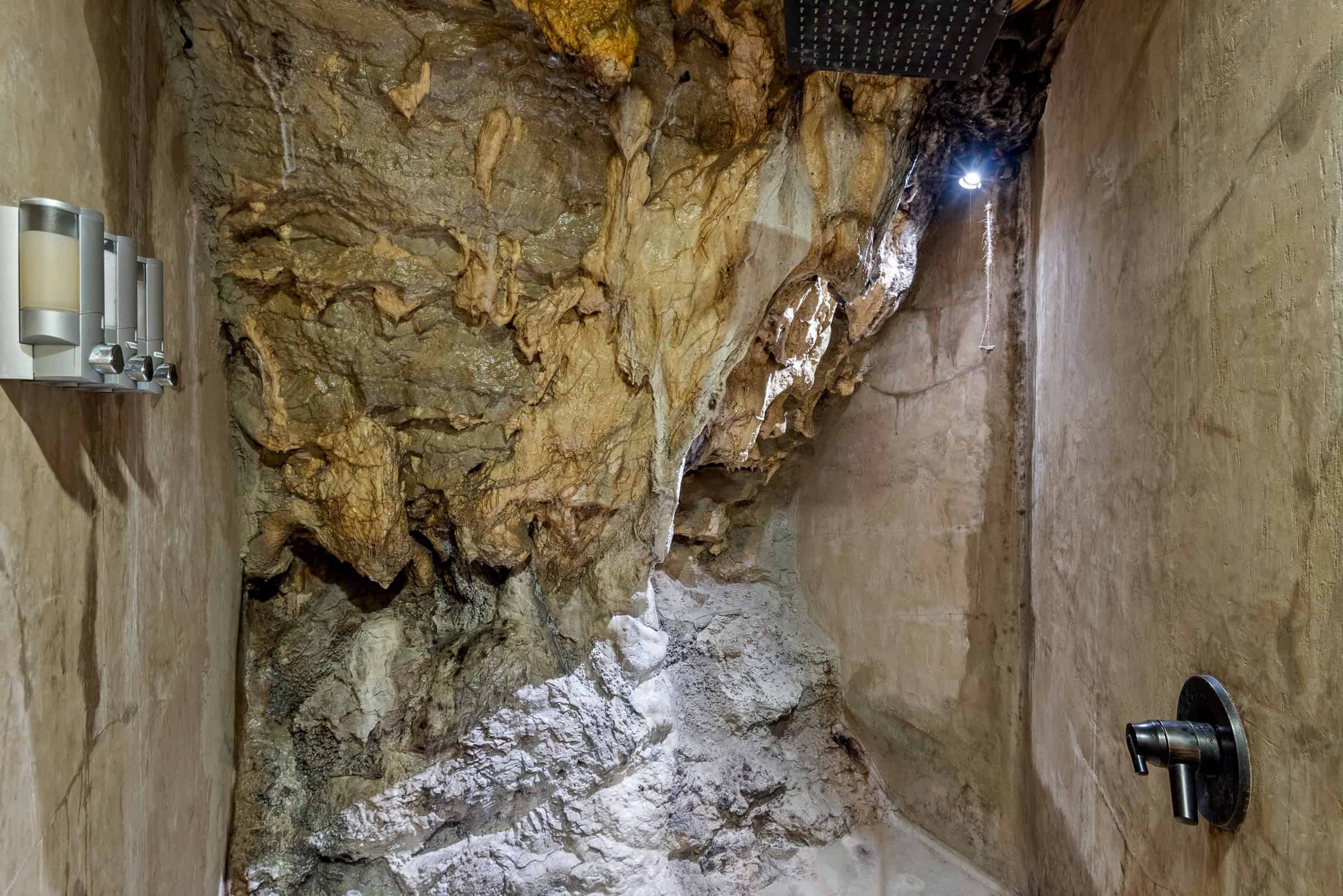 Shower cut into cave rock