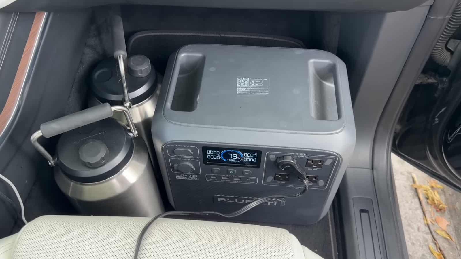 Bluetti portable power station in the front footwell of a Tesla Model X