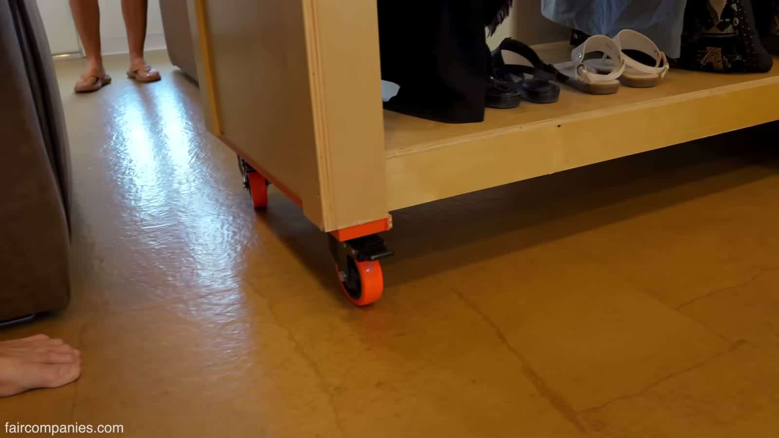 Orange polyurethane casters under a rolling cabinet
