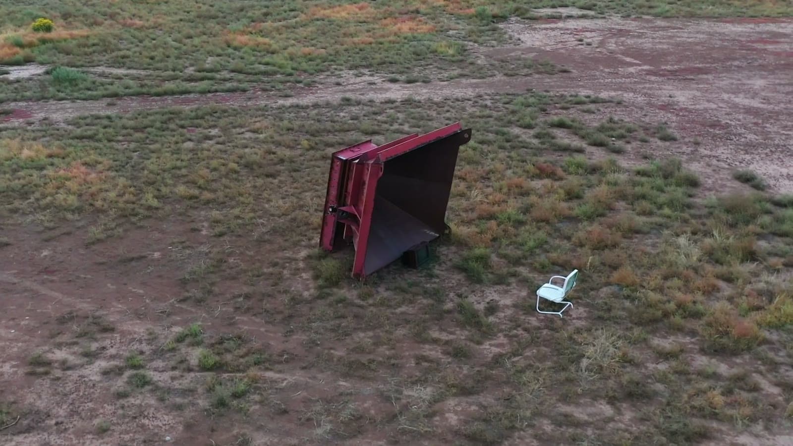 Aerial view of Francis, a salvaged steel crusher sculpture in the desert at Camp V