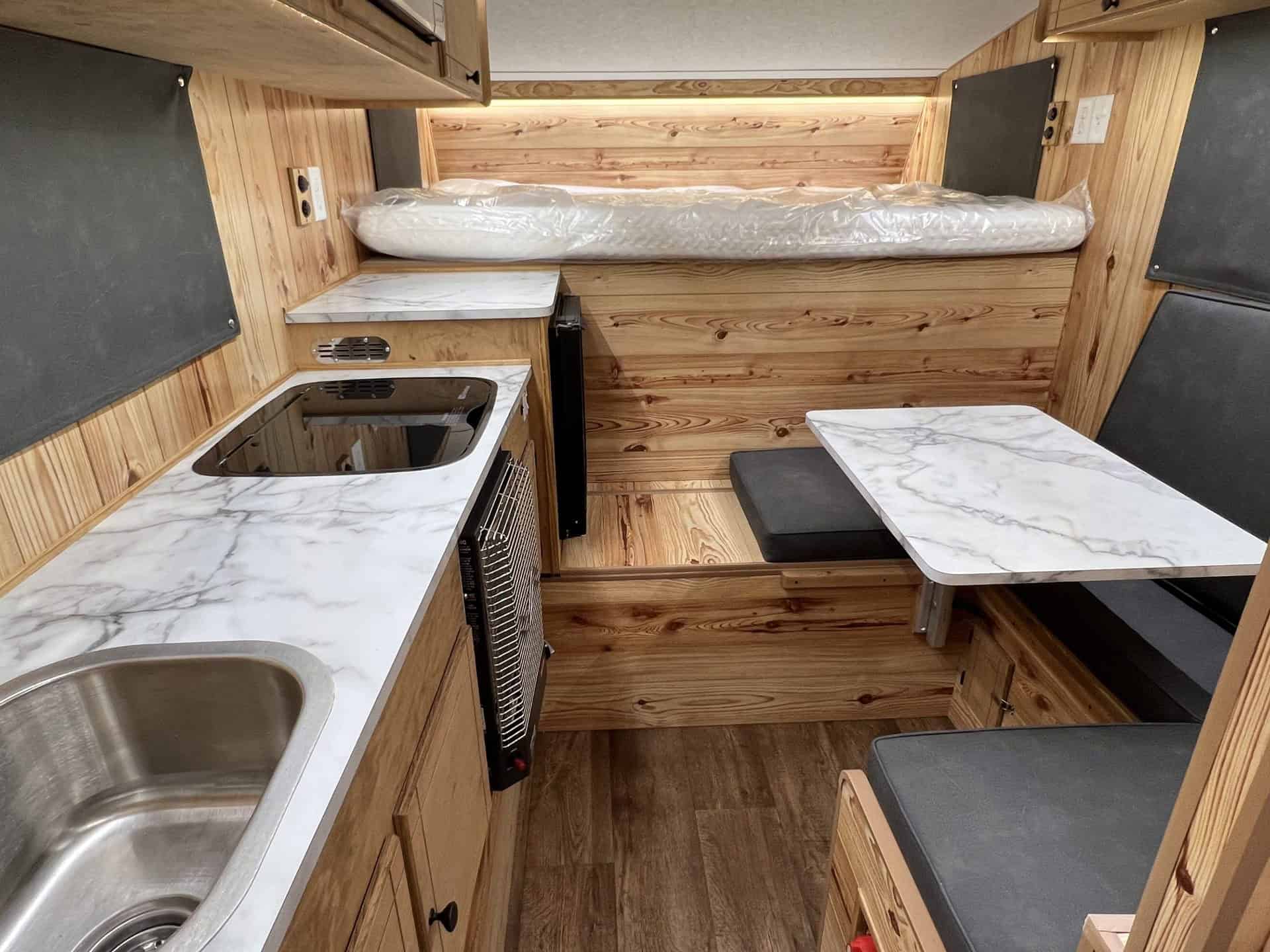 Capri Retreat interior with Ridge Pine wood grain and steel-blue finish accents