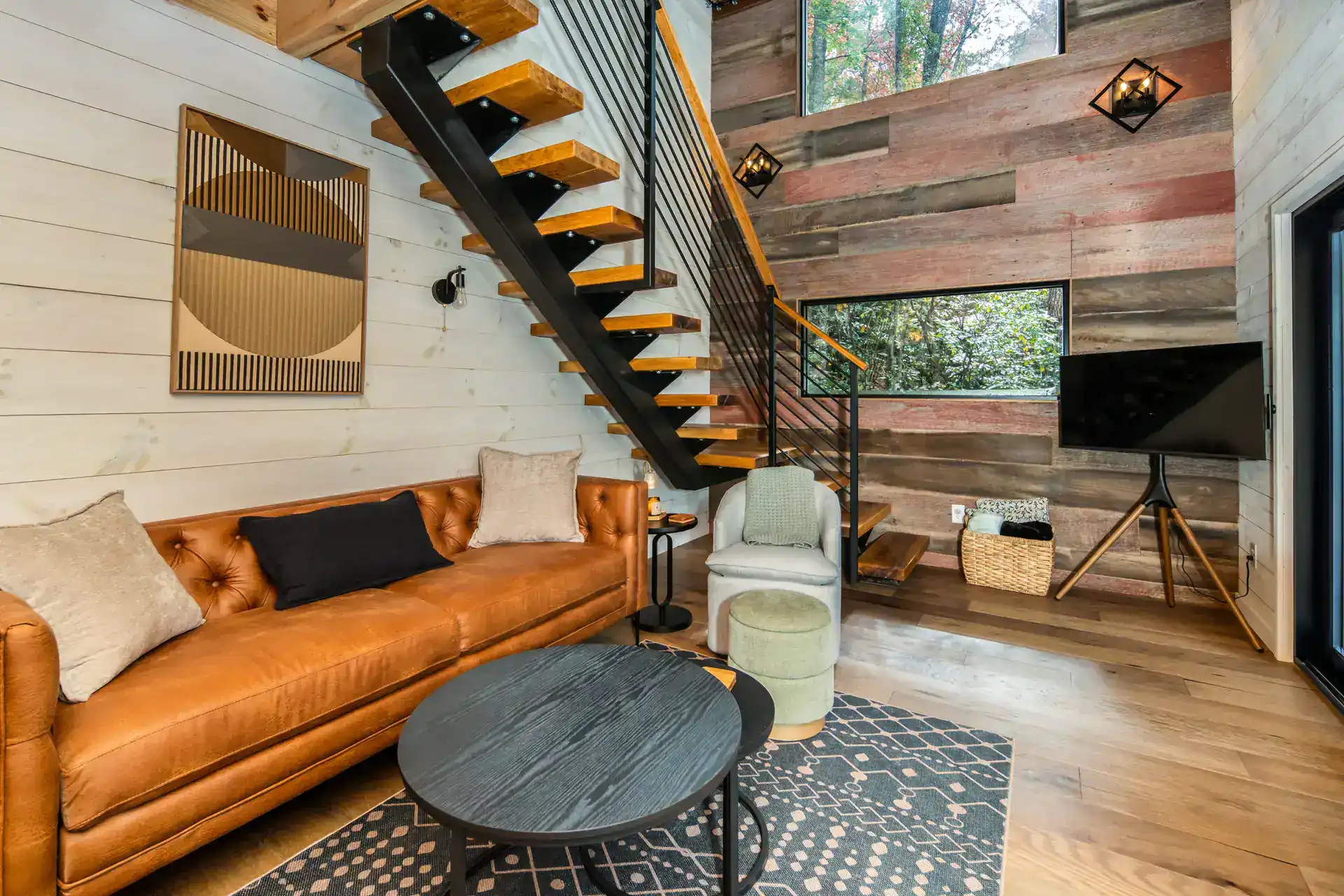 Interior living area with leather sofa and floating stair at The Carpentree
