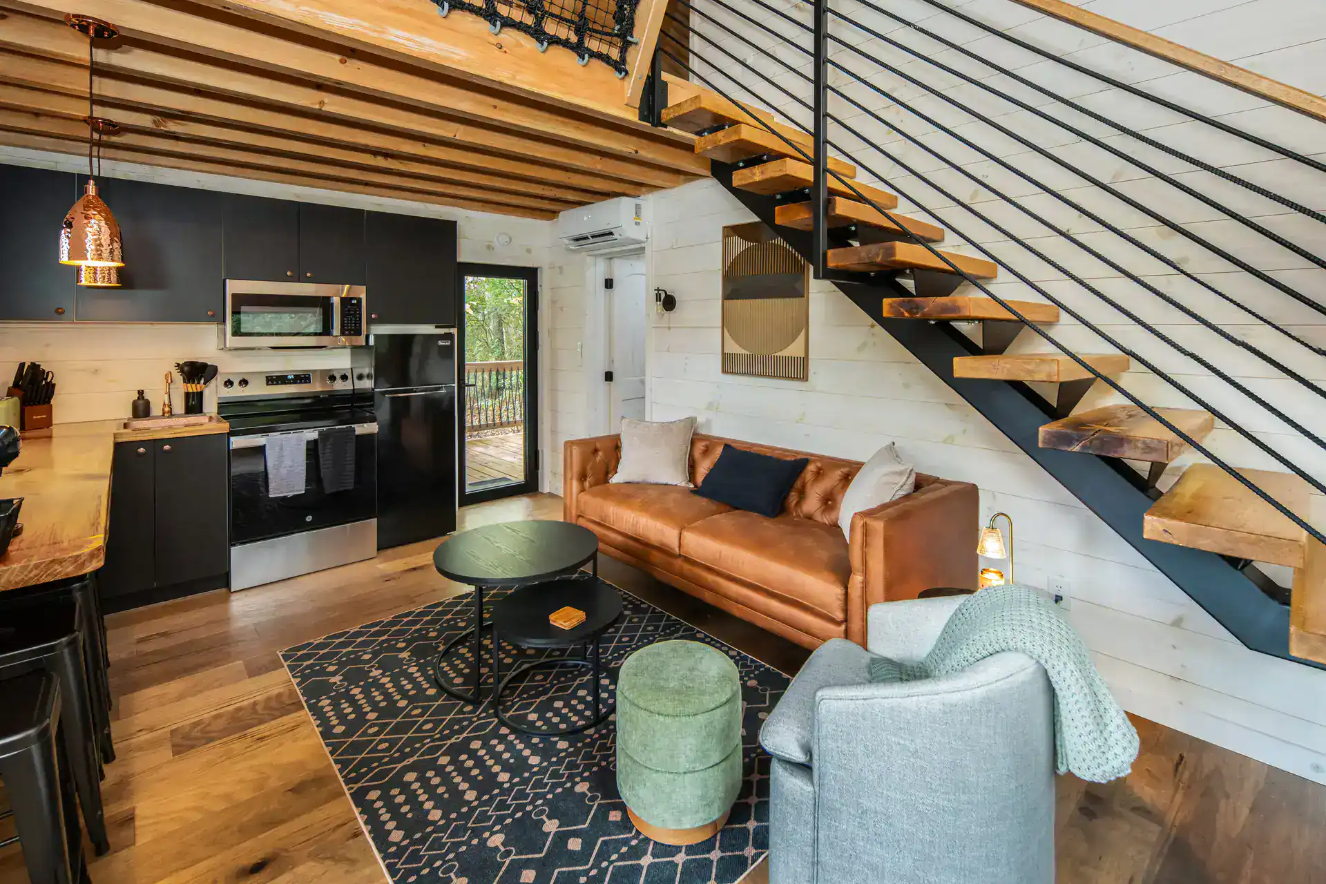 Kitchen and living area with indoor net loft above at The Carpentree