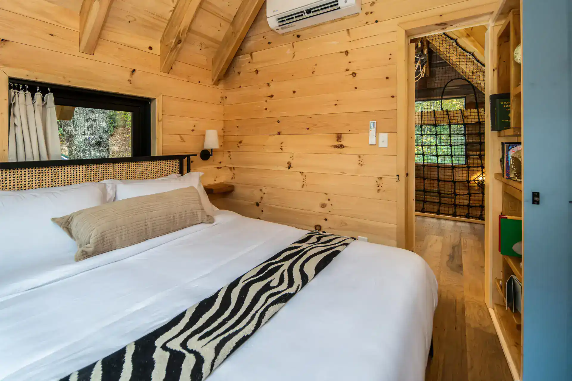 Bedroom with doorway opening to the indoor net loft at The Carpentree