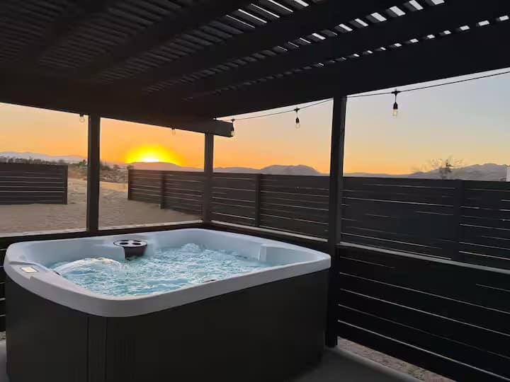Private hot tub under a pergola at sunset