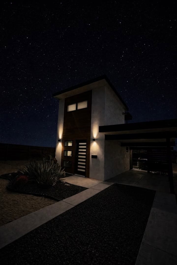 Casita Conejo lit up at night under a dark desert sky