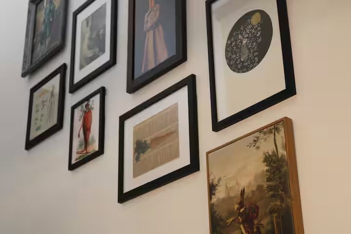 Gallery wall of framed rabbit-themed art along the staircase
