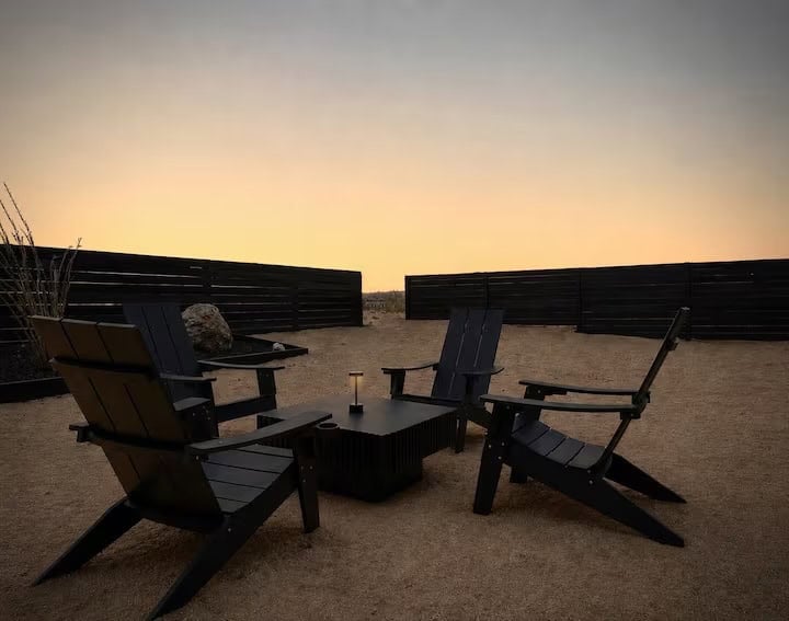 Backyard fire pit with Adirondack chairs at dusk, the stargazing spot