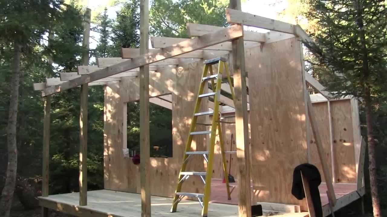 Mid-build 5x16 deck and shed-roof porch on Dave Whipple off-grid cabin