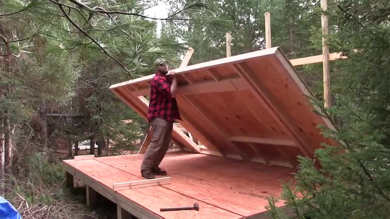 Dave Whipple raising a sheathed wall on his 10x16 off-grid cabin