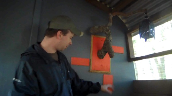 Deek showing off his new DIY Rustic Lantern Hanger in his Tiny Cabin