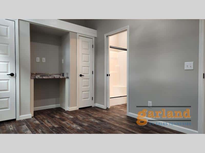 Cozy Cabin built-in desk niche between doors with bath doorway beyond