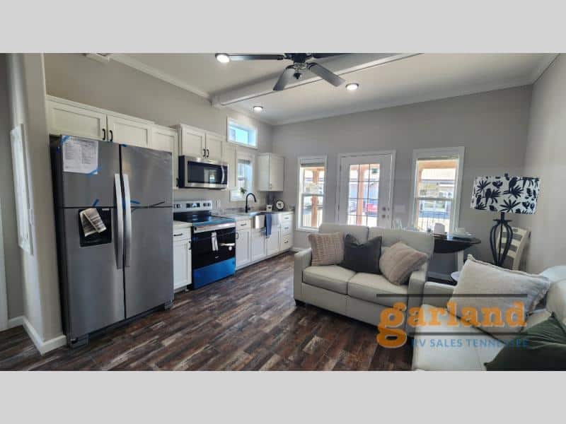 Cozy Cabin open living and kitchen: white shaker cabinets, farmhouse sink, stainless appliances