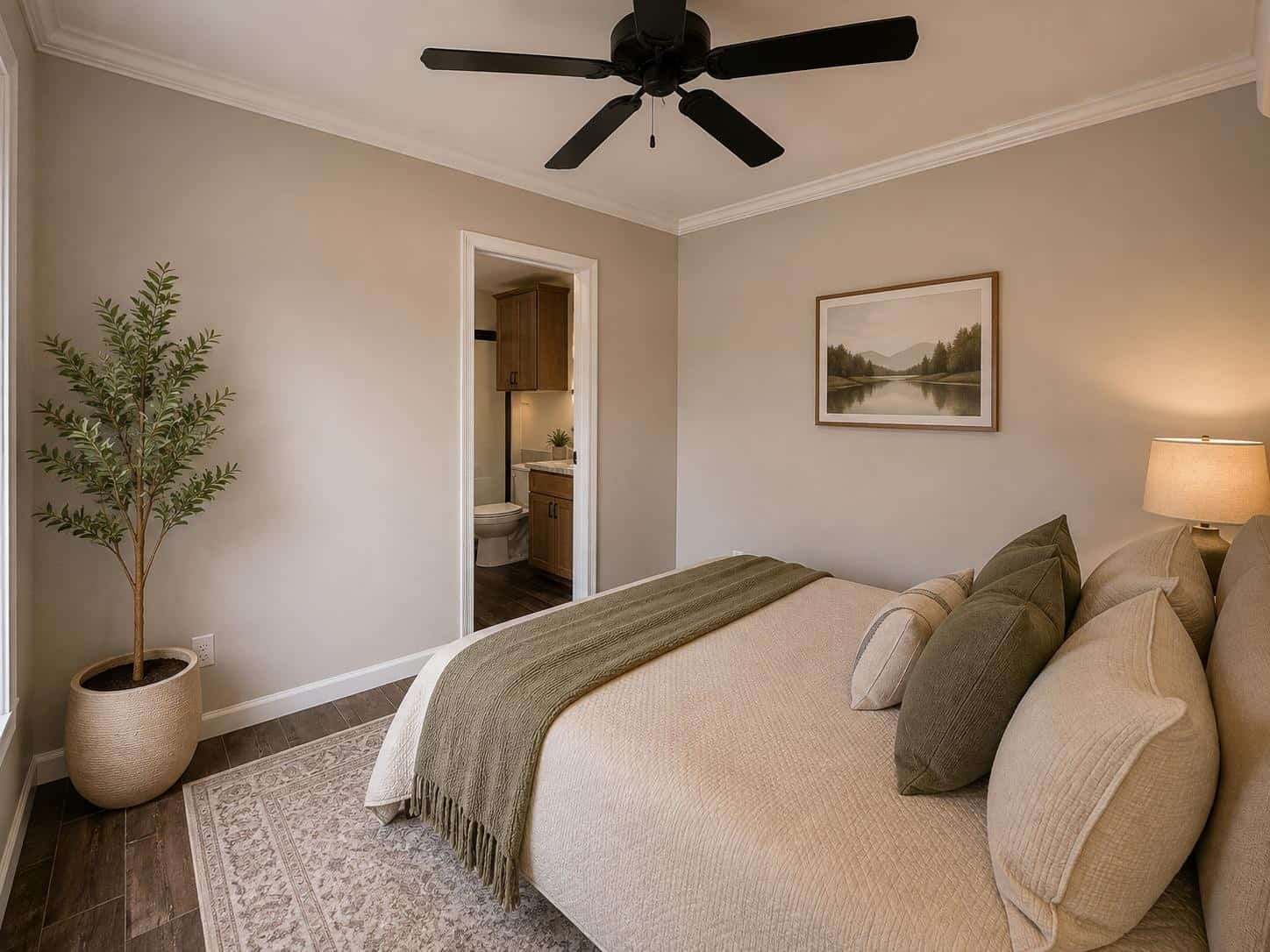 Fawn Unlimited bedroom: cream bedding, sage pillows, ensuite bath doorway, ceiling fan