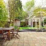 Deltec Backyard Cottage circular home exterior in a landscaped setting